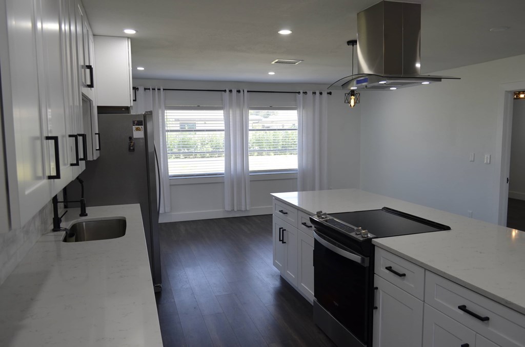 a recent kitchen remodel with white cabinets and black appliances