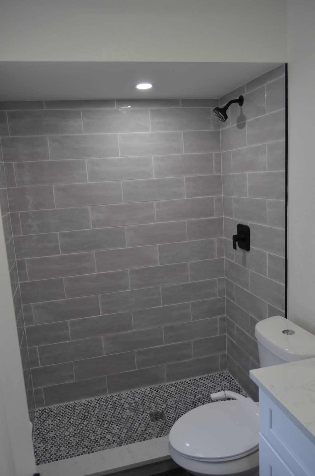 a small bathroom with a shower and a toilet