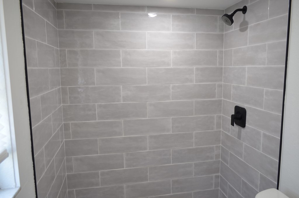 a bathroom with a shower and a toilet in it