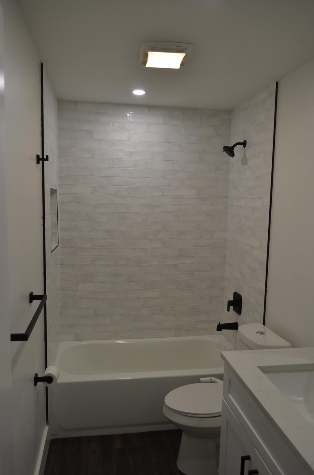 a small bathroom with a shower and a toilet and a sink