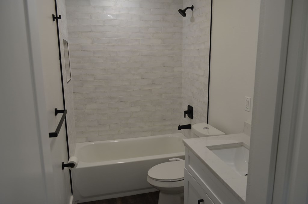 a small bathroom with a tub and a sink and a toilet