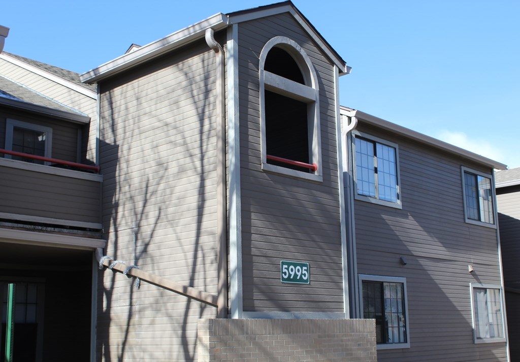 A grey house with the number 5996 on the front.