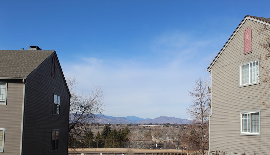 Two houses with a mountain range in the background.