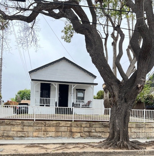 a white house with a large tree in front of it