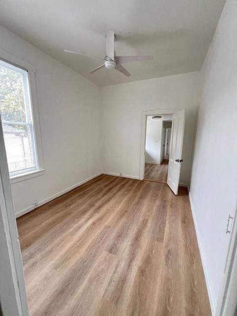 a living room with a wood floor and a ceiling fan