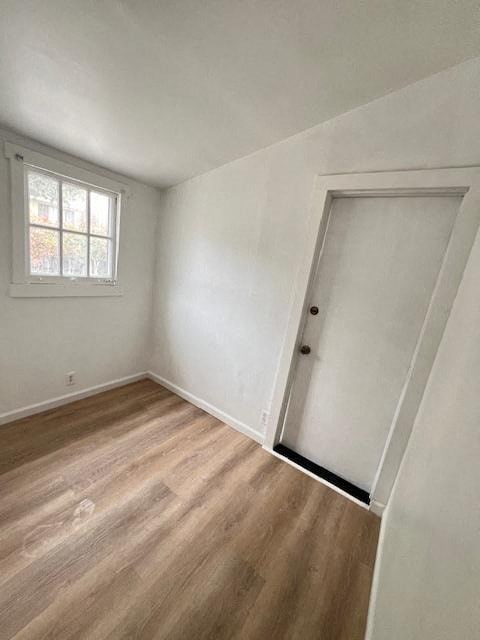 an empty bedroom with a door to a closet