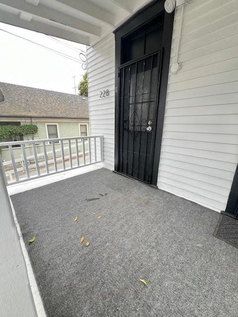 a front porch of a house with a black door