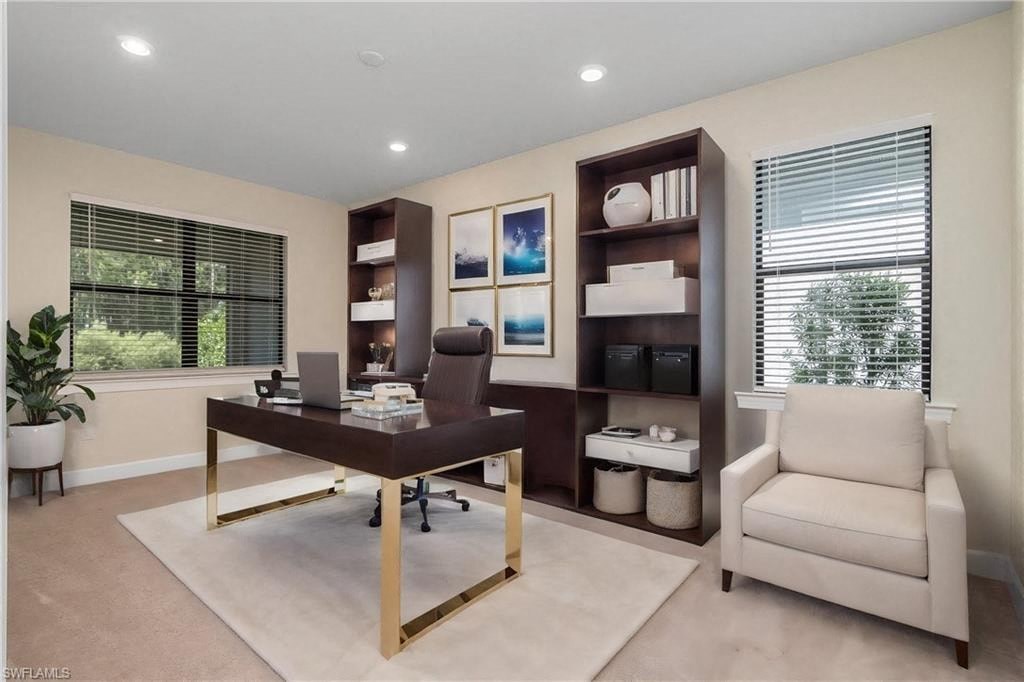 a home office with a desk and chair and a window