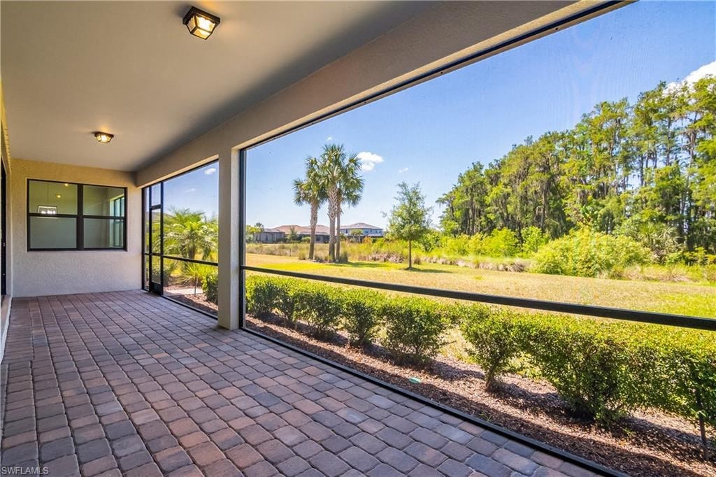the view from the front porch of a house with large windows