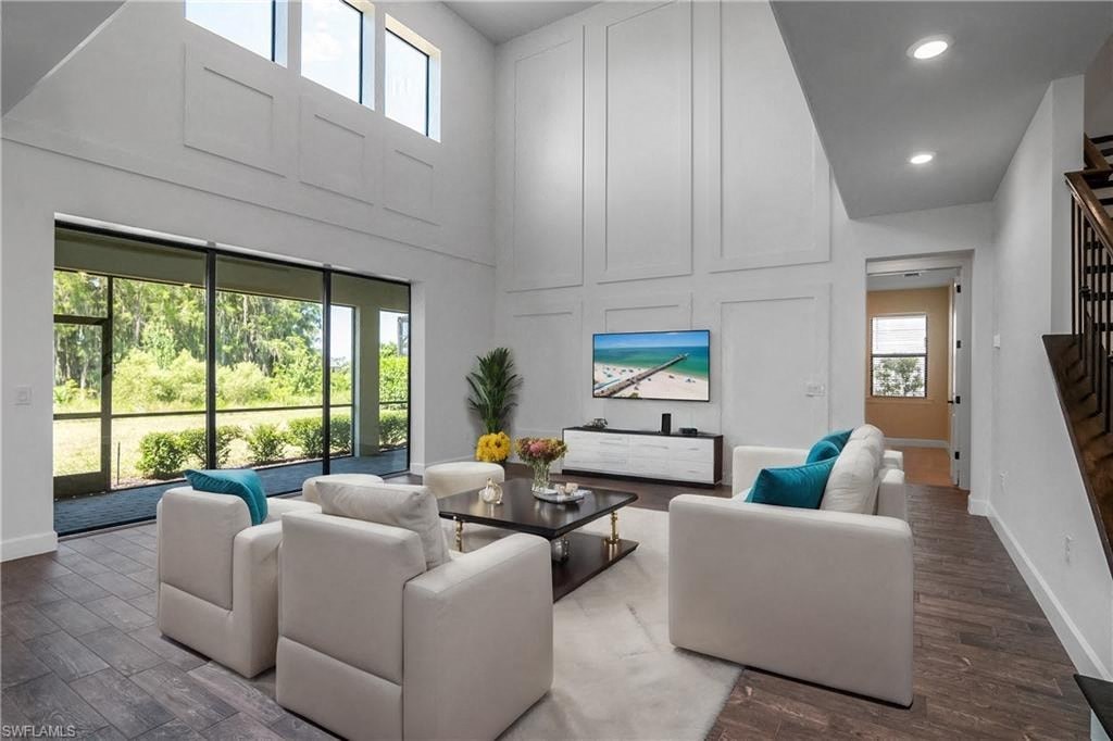 a white living room with couches and a tv