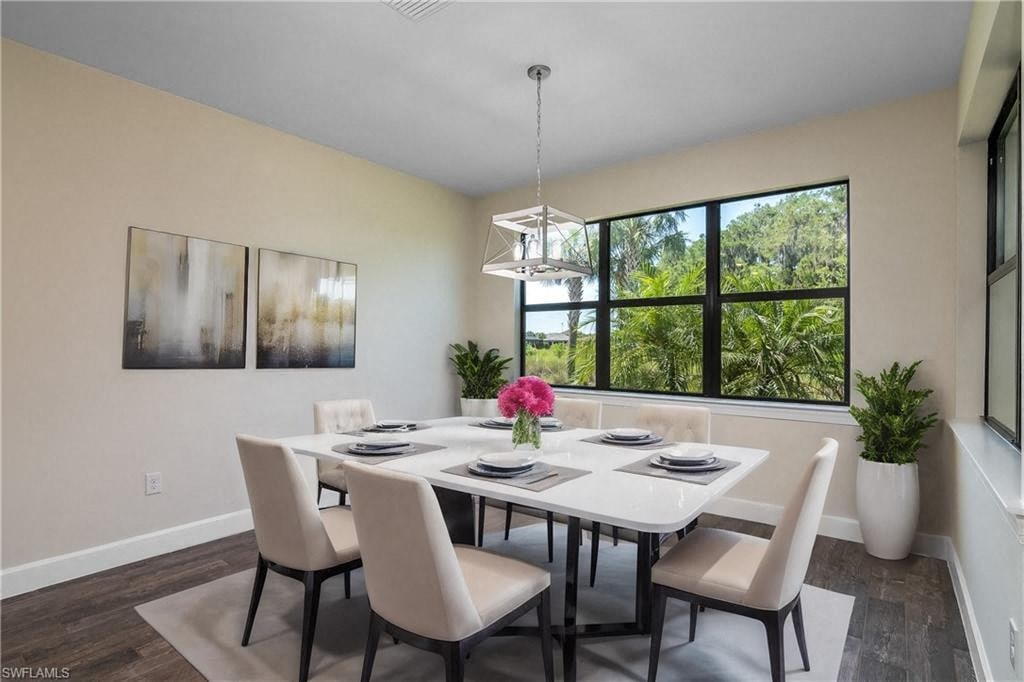 a dining room with a table and chairs and a large window