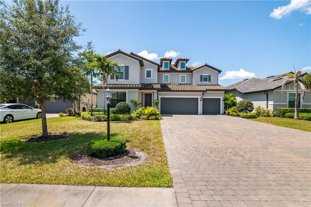 a large house with a driveway and a car garage