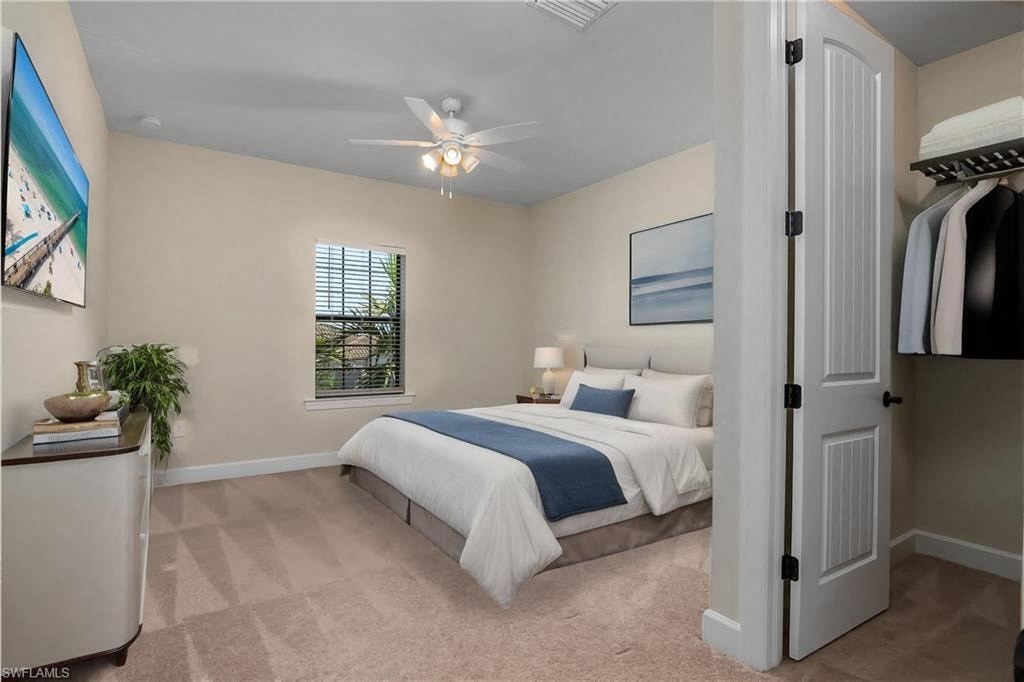 a bedroom with a bed and a ceiling fan