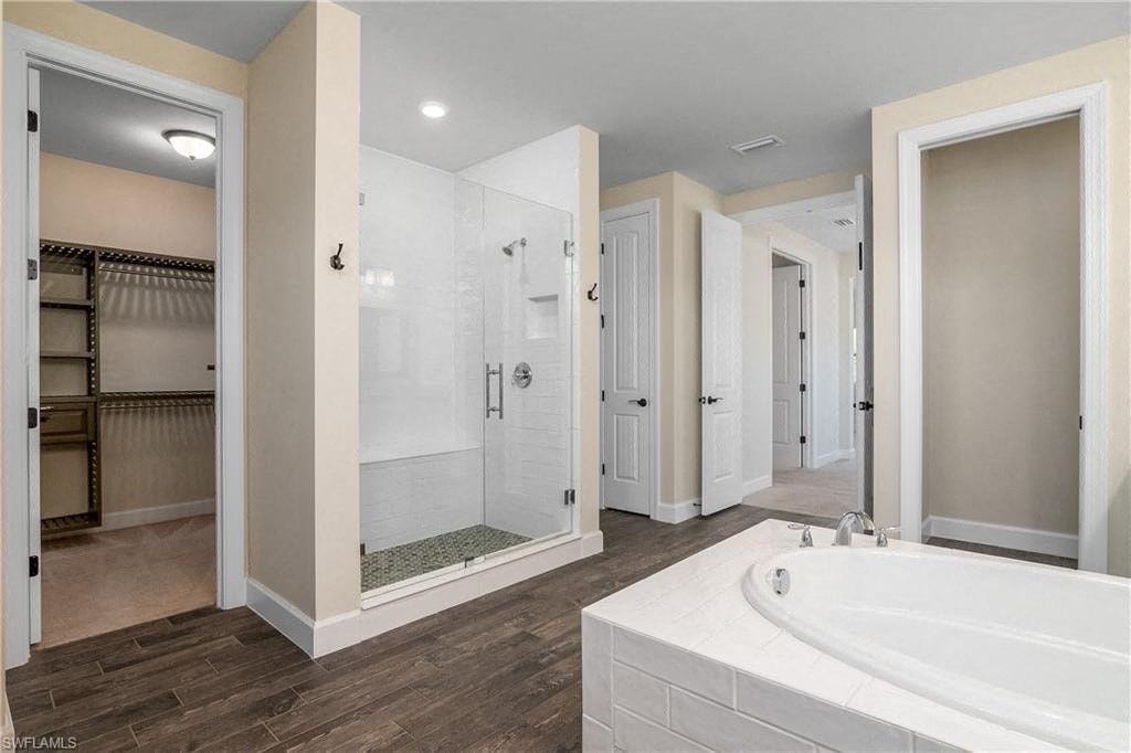 a large bathroom with a large tub and a shower