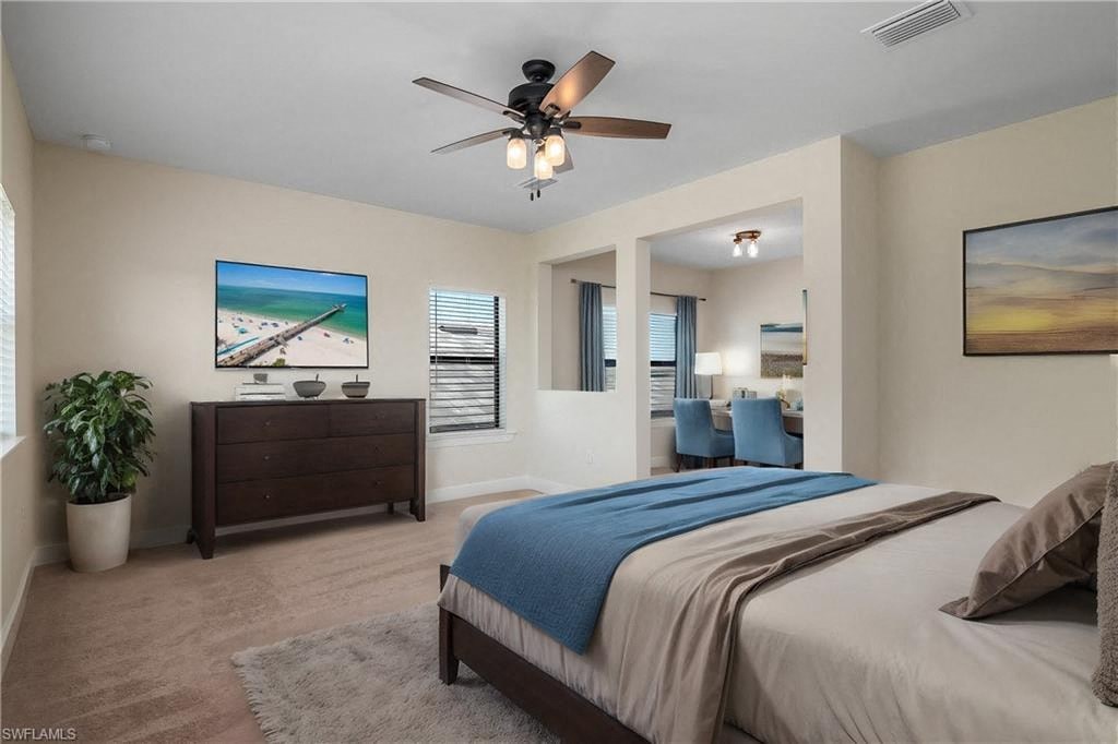 a bedroom with a bed and a ceiling fan