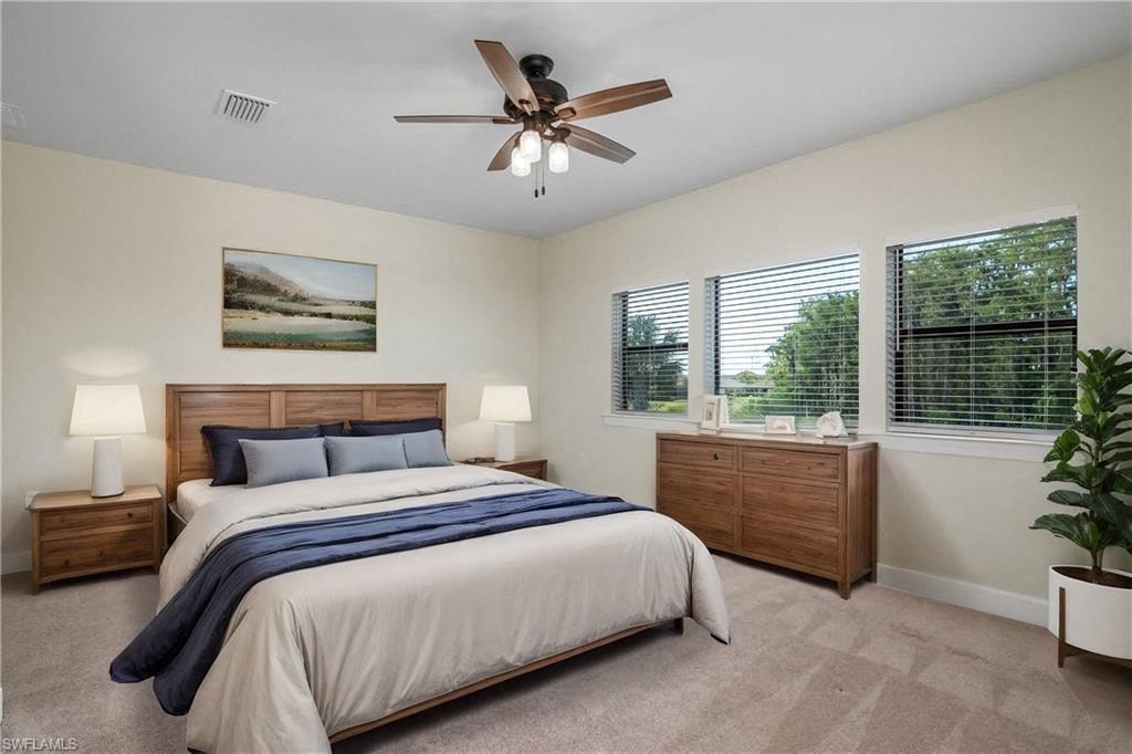 a bedroom with a bed and a ceiling fan