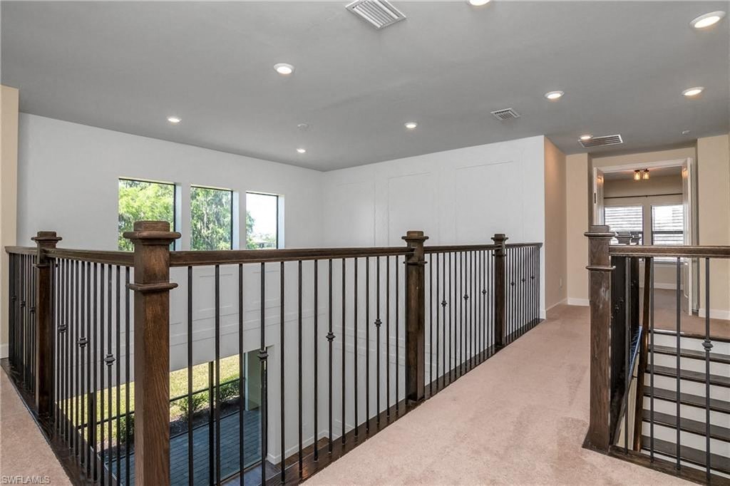 a large white house with a railing and a staircase