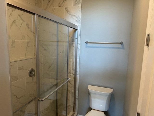 a bathroom with a toilet and a glass shower