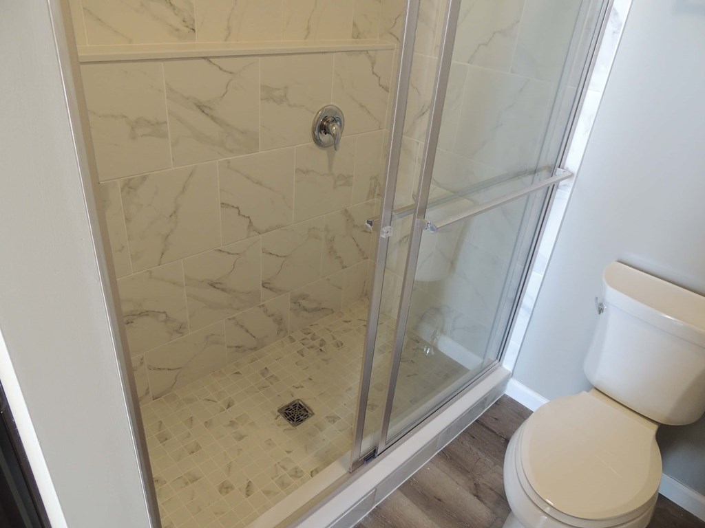 a small bathroom with a shower and a toilet