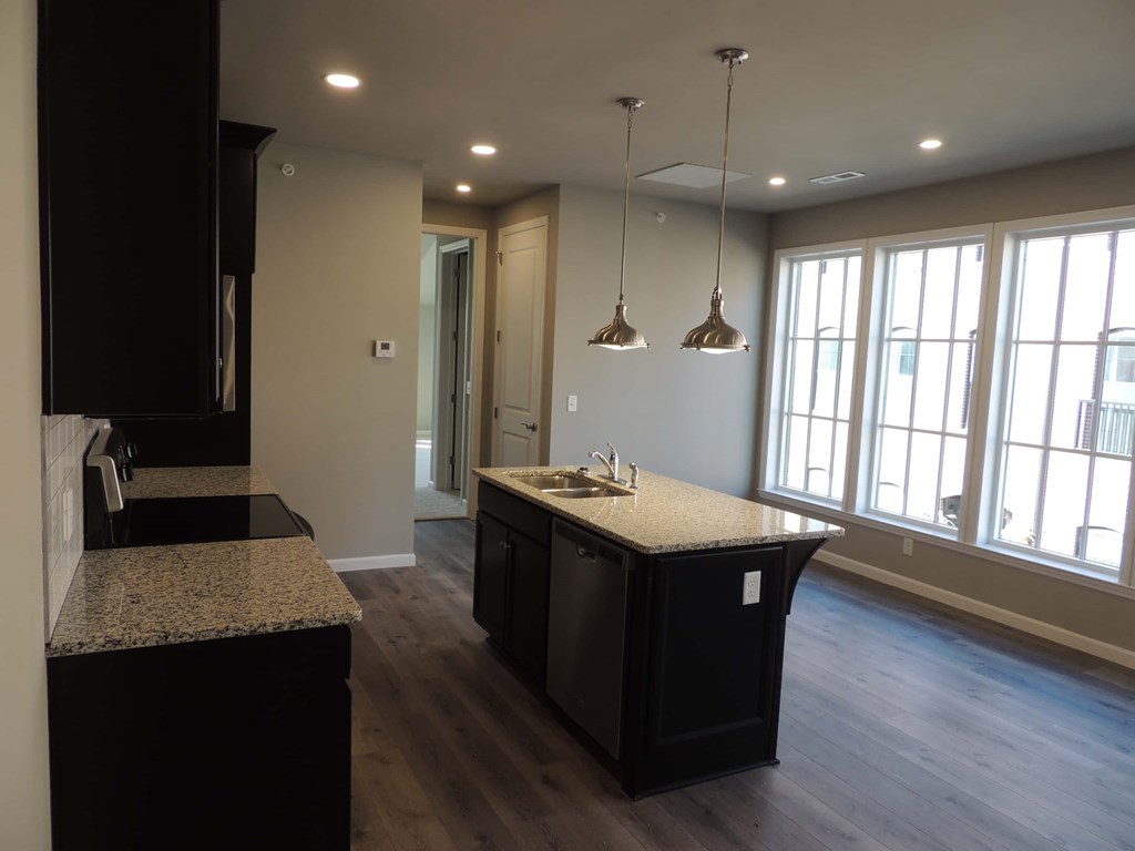 a kitchen and living room with a large window