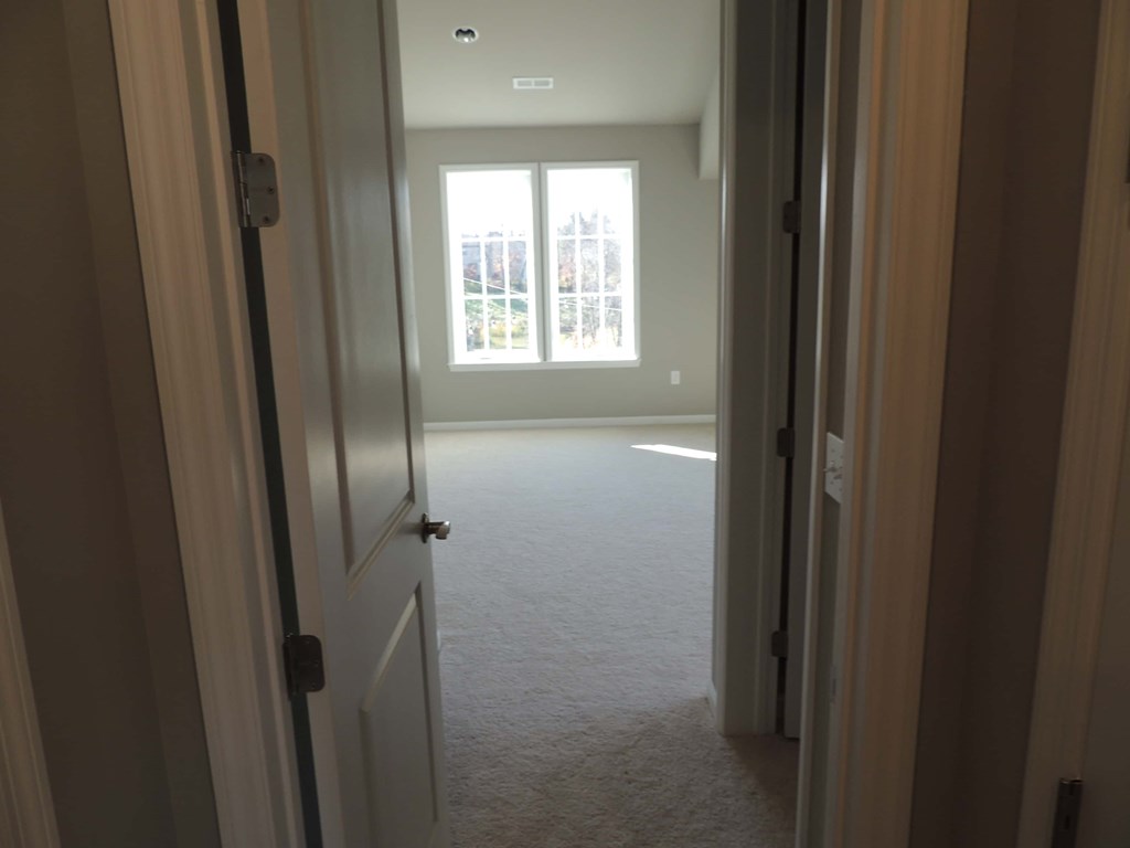 the living room from the kitchen looking into the empty bedroom