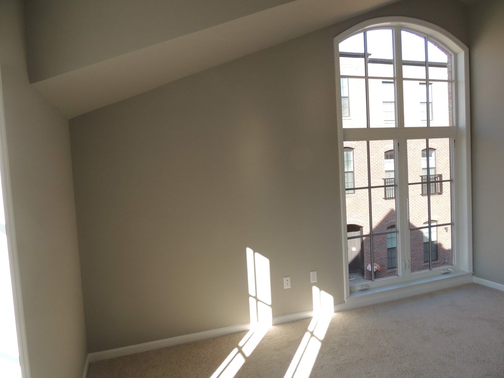 an empty living room with a large window