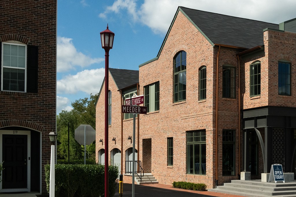 a brick building with a street sign and a street light