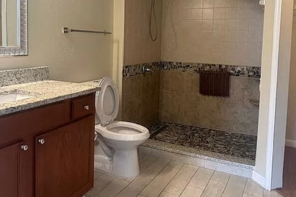 a bathroom with a toilet and a shower