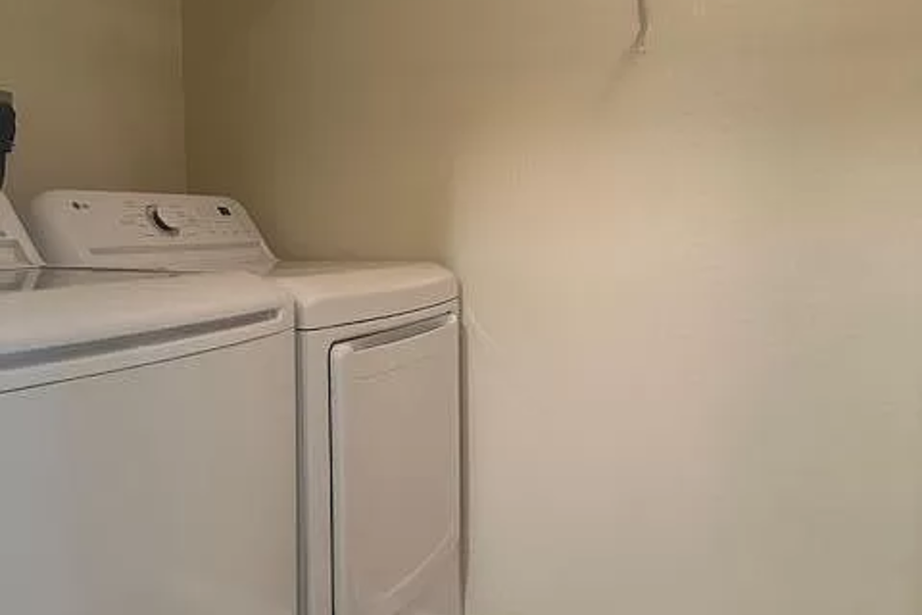 a white washer and dryer in a white room