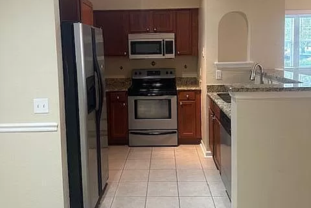 a kitchen with a stove and a refrigerator