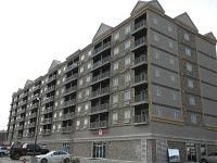 an apartment building with cars parked in front of it