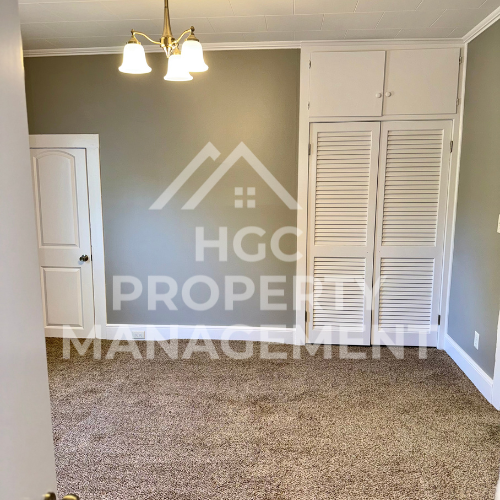 a room with a carpet and two closets