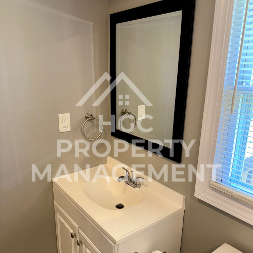 a small bathroom with a sink and a mirror