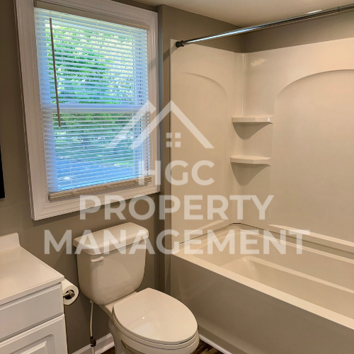 a small bathroom with a toilet and a bath tub