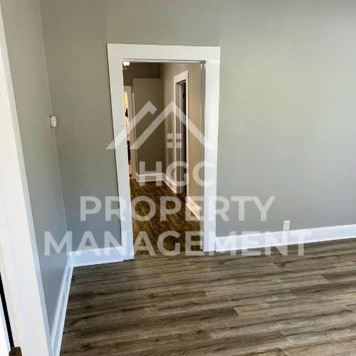 a renovated living room with a door open to a hallway