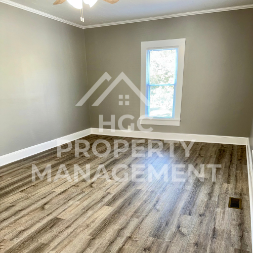 a room with hardwood flooring and a window