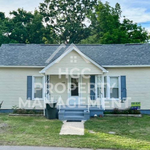 a small white house with blue doors and a porch
