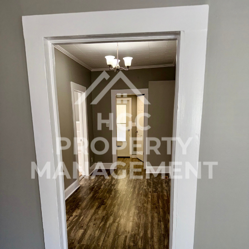 a hallway with a door to a bedroom and a closet