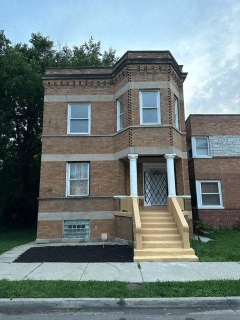 an old brick building with stairs and a door