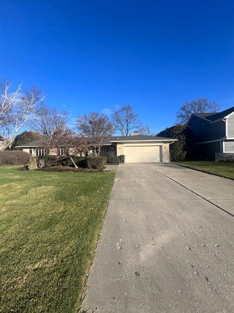 a house on the side of a street with a driveway