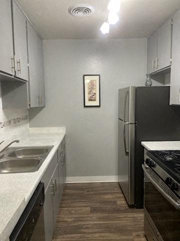 a kitchen with a sink and a refrigerator