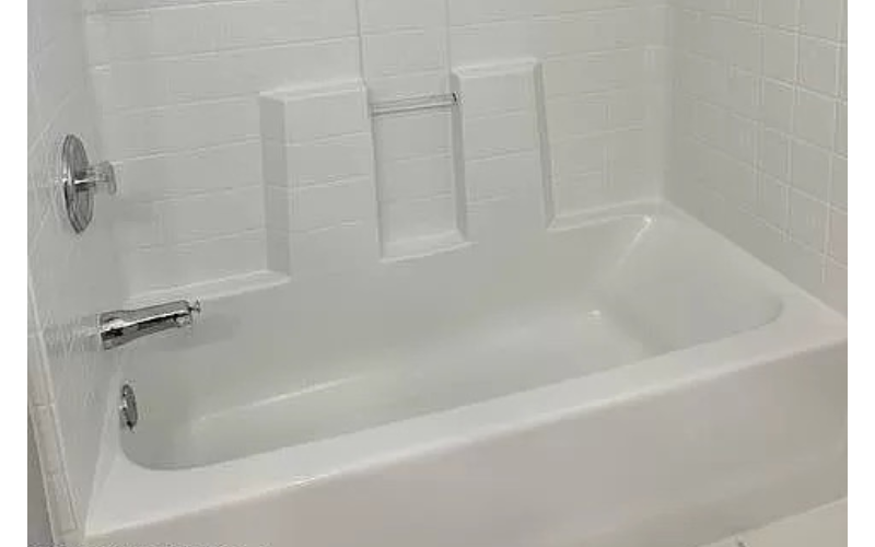 a white bath tub in a white bathroom