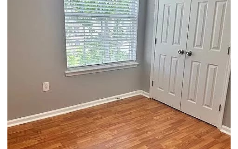 a door and a window in a room with a wooden floor