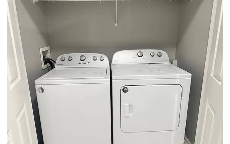 two white washers and dryers in a small room