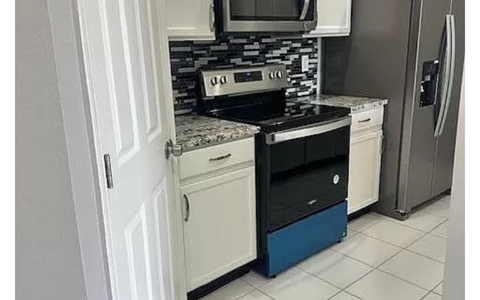 a kitchen with a stove and a refrigerator
