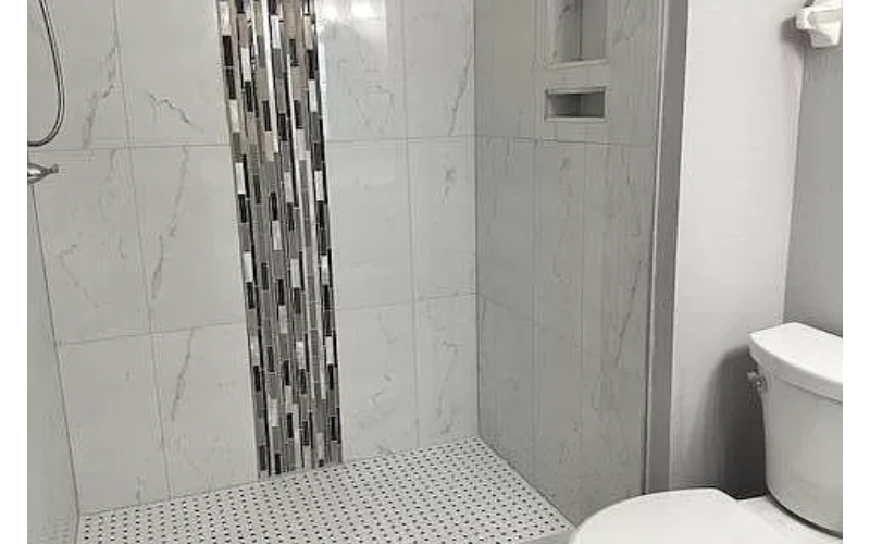 a white bathroom with a shower and a toilet