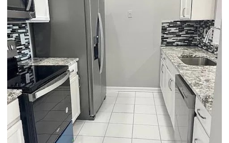 a kitchen with a sink and a refrigerator