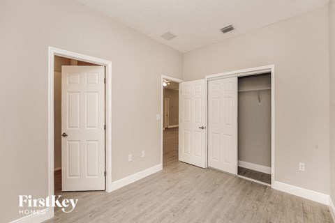 a bedroom with two closets and a door to a hallway