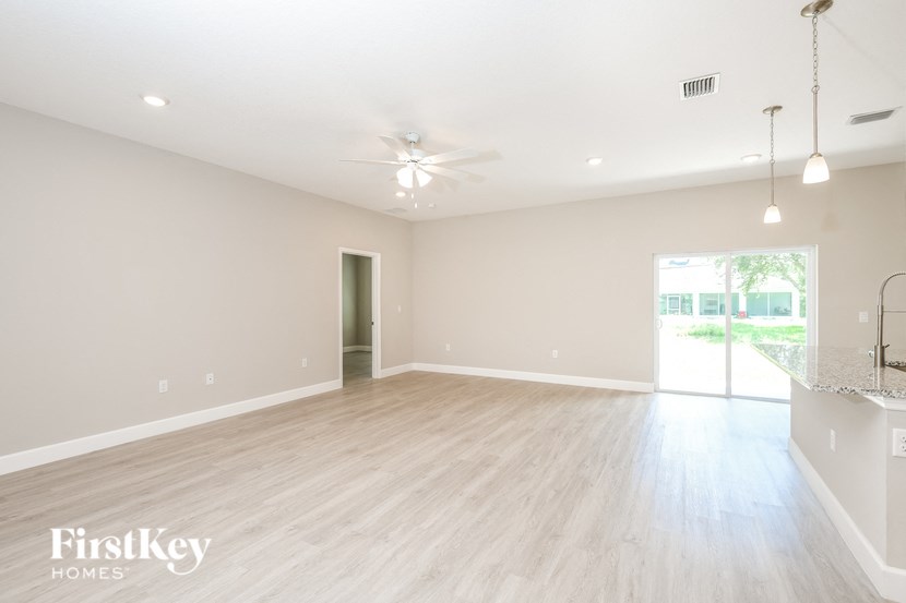 the living room and dining room of a new home