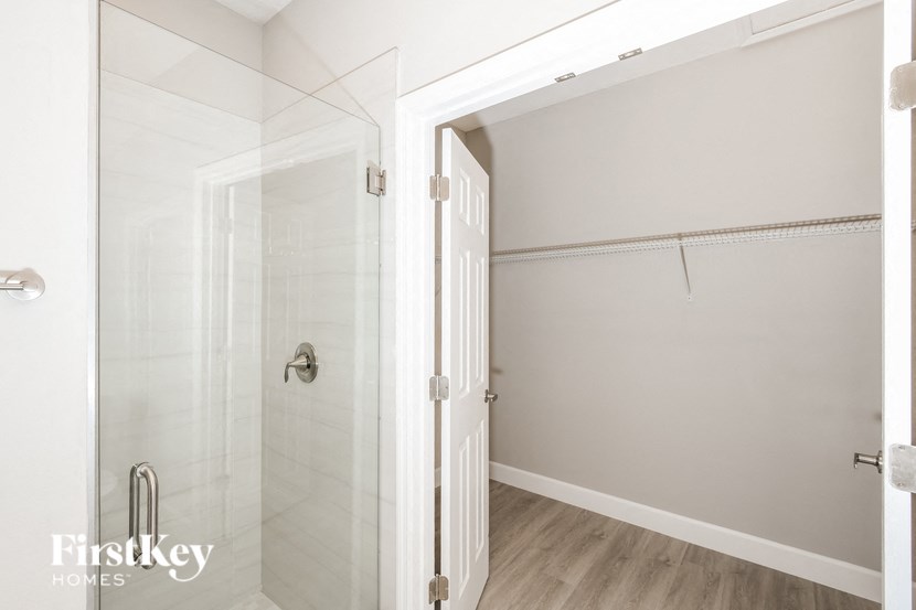 a bathroom with a shower with a glass door